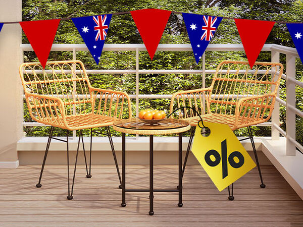 Outdoor furniture set with two wicker chairs and a table under a banner of red and Australian flag pennants. A yellow discount tag is attached. Click to see the products in the collection.
