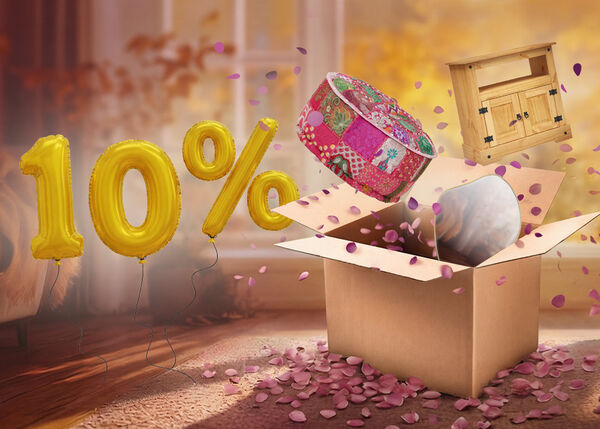 Open box with colourful pouffe, wooden TV cabinet, and mirror popping out, purple petals scattered around in an indoor setting. Yellow balloons show a 10% discount.