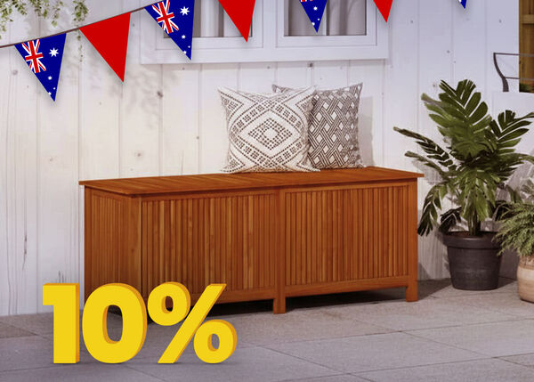Wooden bench with patterned cushions on a patio, decorated with Australian flag buntings and a percentage discount tag hanging from the bench.