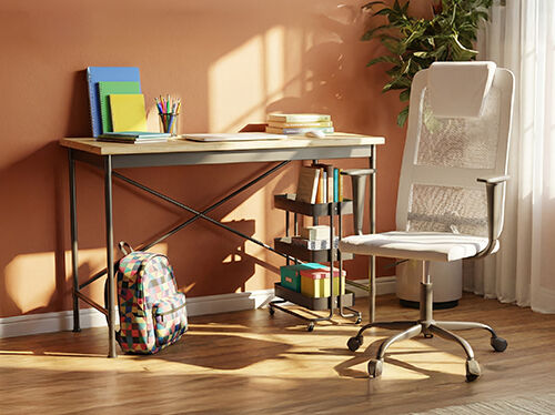 A wooden desk with metal frame, white mesh office chair, storage cart, a colorful patterned backpack, and school supplies in a styled study room. Click to see the products in the collection.