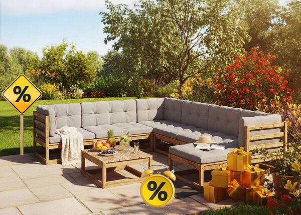 A wooden outdoor furniture set with grey cushions, a matching coffee table, yellow gift boxes, a sign and a clock with discount icons, all on a styled patio.