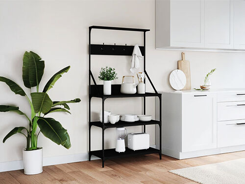 Black metal baker's rack with kitchenware and hooks, in a styled kitchen. Click to see the products in the collection.