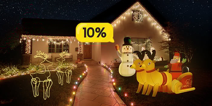 House decorated with inflatable snowmen, glowing reindeer and LED lights. Yellow discount bubble in the centre shows 10%. Click to see the products in the offer.
