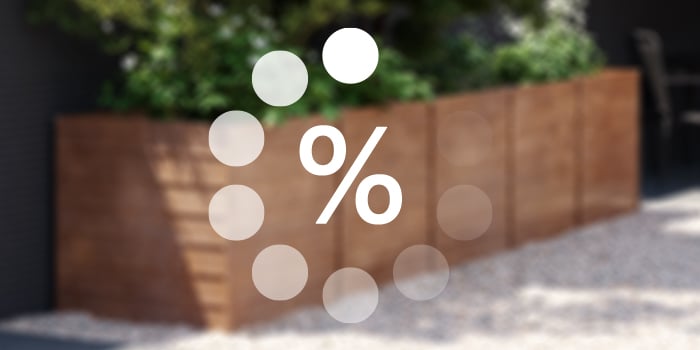 Discount promotion featuring a white circle graphic with a percentage symbol overlaid on a blurred background of a living room with a leather sofa and wooden coffee table.