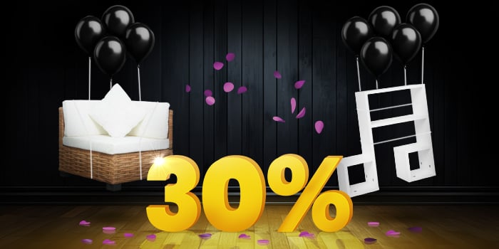 Rattan corner seat with white cushions and white wall shelves lifted by black balloons and surrounded by purple confetti, with a large yellow 30% sign on a dark background. Click to shop the collection.