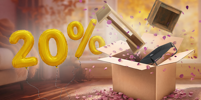 Open box with monitor stand, bedside cabinet, and dog bed popping out, purple petals scattered around in an indoor setting. Yellow balloons show a 20% discount. Click to shop the collection.
